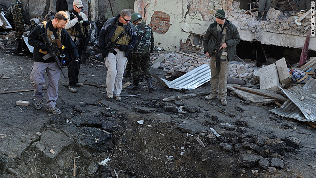 Foreign investigators inspect a crater left by the blast on Tuesday December 15 in Kabul.