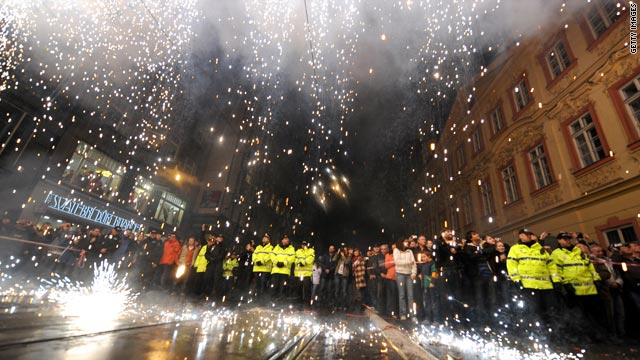 Czech people watch a symbolic "iron curtain" burning in Prague.