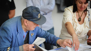 An election worker helps an elderly man cast his vote in Bucharest.