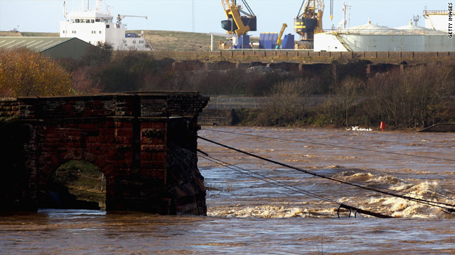 The remains of a bridge in Workington, England  where a police officer was swept away to his death when it collapsed.