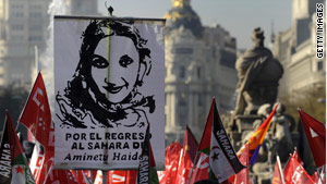 People hold Western Saharan flags and a poster of Aminatou Haidar during a demonstration on Dec 12.