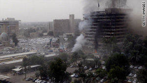 Two car bombs exploded outside Iraqi government buildings, killing dozens of people on Sunday.