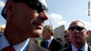 Tony Blair (center) surrounded by bodyguards at the opening Tuesday of a crossing between Israel and the West Bank.