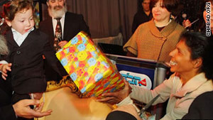 Moshe Holtzman celebrates his third birthday with nanny Sandra Samuel.