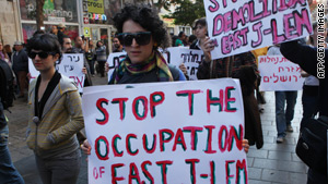 Israeli left wing activists hold placards during a rally in downtown Jerusalem.