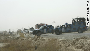 Iraqi police vehicles block the entrance to Camp Ashraf during a skirmish in July.