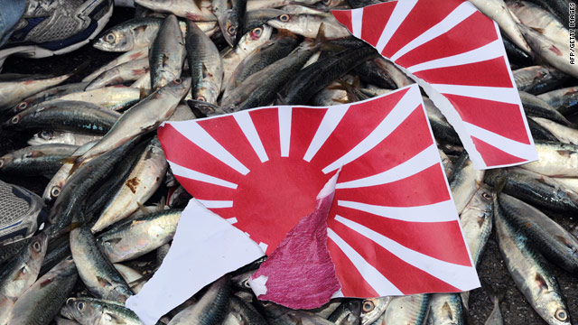 A torn apart Japanese 'Rising Sun' flag is placed on dead fish during a demonstration in front of the Japan Exchange Association - Japan's representative office on Taiwan- on September 14 over the continued island dispute between Tokyo and Beijing.