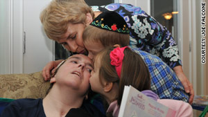 Abbie Dorn is kissed by her mother, Susan Cohen, and  nephew and niece,  Mani and Esti.