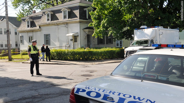 Law officers cordoned off a home in Watertown, Massachusetts, on Thursday, part of several raids in the Northeast.