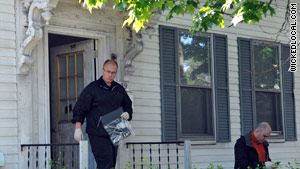 An investigator carries a plastic bag from a house in Watertown, Massachusetts, on Thursday.