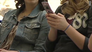 A school district is being sued after a woman claims officials saw semi-nude photos on her cell phone and notified police.