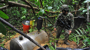 A Colombian soldier looks over part of a cocaine-making operation run by the rebel group FARC.