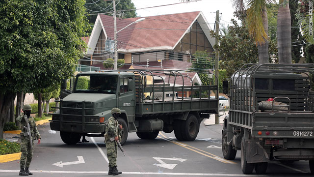 Elite Mexican army units stand guard after an anti-drug raid that killed Ignacio Coronel Villareal in Guadalajara, Mexico,  Thursday.