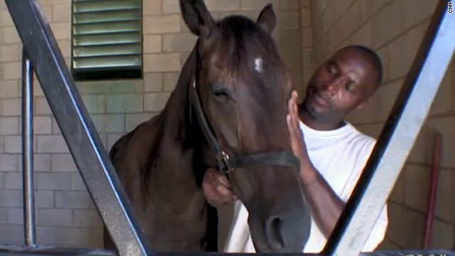 Prison inmate Alonzo Pickett handles Greek, a retired Thoroughbred racehorse, at a prison farm in Maryland.