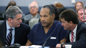 Attorneys Gabriel Grasso, left, and Yale Galanter talk with O.J. Simpson at his sentencing in December 2008.