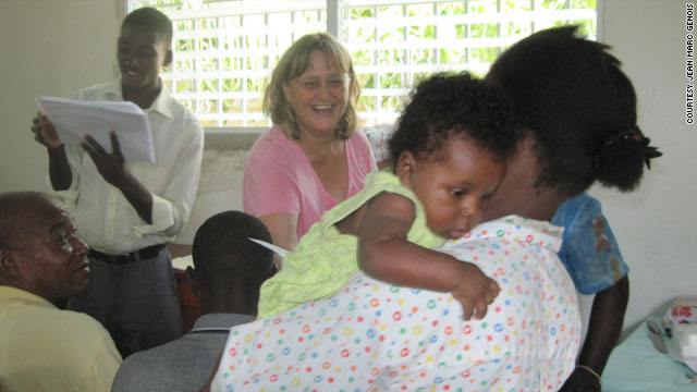 Gale Hull, center, president of Partners in Development, delivers loans to small business owners in December 2009.