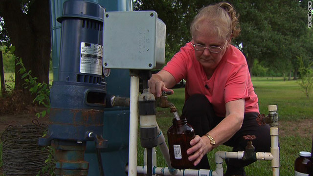 Chemist and environmental activist Wilma Subra collects a water sample in Gueydan, Louisiana.