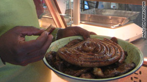 Tembela Mawela holds a platter of meat from Mzoli's, a restaurant and butcher shop.