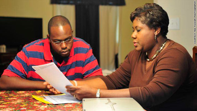 Joshua and Delores Armstrong look at a hospital bill together. A $10,000 emergency room charge shocked the family.