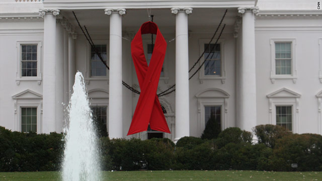 A giant red ribbon hangs on the White House for observance of World AIDS Day.