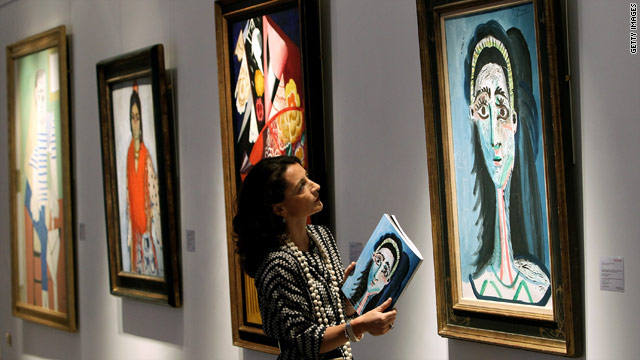 A Christie's employee inspects a work titled "Tete de Femme" by Pablo Picasso, which is among works to be auctioned.