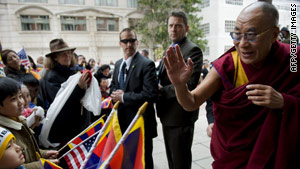 The Dalai Lama greets a crowd celebrating the Tibetan New Year outside a Washington hotel.