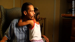 Ralph Benitez gets a hug from his grandaughter Kayla.