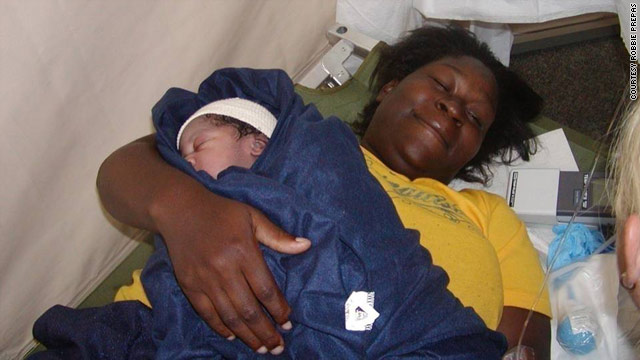 A mother rests with her baby just after delivery at the New Orleans airport amid the chaos of Katrina.