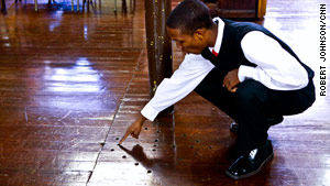 Tour guide Johnny McDonald shows air holes designed like an African prayer symbol and said to help runaway slaves.