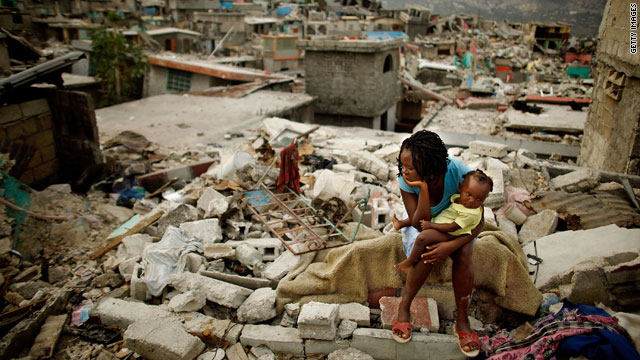 Sherider Anilus, 28, and her daughter, 9-month-old Monica, sit on the spot where her home collapsed during last month's earthquake in the Fort National neighborhood of Port-au-Prince, Haiti.