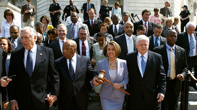 Speaker of the House Rep. Nancy Pelosi, D-California, carries the gavel that was used when Medicare was passed while walking with other congressional Democrats to the Capitol before the health care vote Sunday.