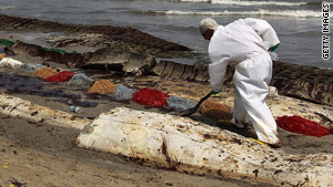 A BP cleanup crew removes oil from a beach in Port Fourchon, Louisiana, on Sunday.