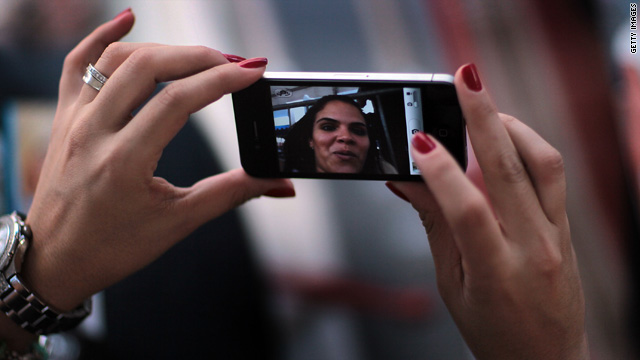 Jackie Quintero checks out a new Apple iPhone 4 as she waits in line to buy her own on June 23 in Miami Beach, Florida.