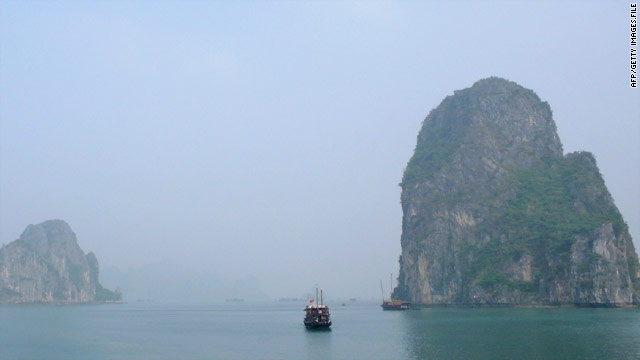 Tourist junks cruise in Halong Bay in the Gulf of Tonkin on the northeastern coast of Vietnam.