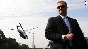 A Secret Service agent stands guard at the White House. A source says the agency may take on air marshal duties.