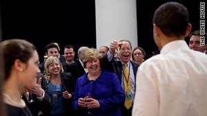 President Obama celebrates with staff on the Truman Balcony of the  White House after the health care vote.