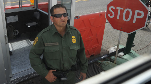 A Border Patrol officer inspects vehicles this week at a checkpoint in Tombstone, Arizona, near the Mexican border.