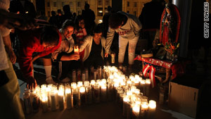 Protesters light candles outside the Arizona Capitol on Thursday night to protest the new illegal immigration law.