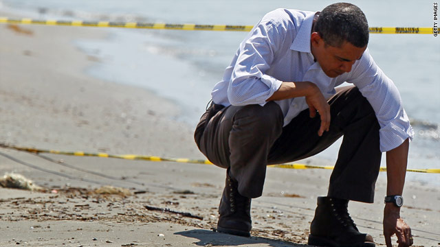 President Obama picks up balls of tar while touring the beach May 28 in Port Fourchon, Louisiana.