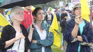 Tea Party activists brave the wet weather to protest what they consider out-of-control government spending.