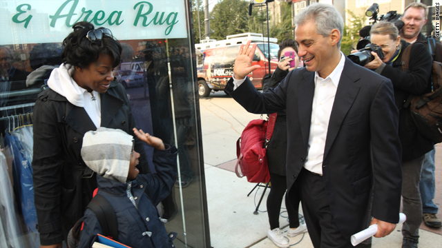 Ex-White House official Rahm Emanuel swings by a bus stop in Chicago last month. The crowd was friendlier on that visit.