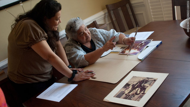 Christine Acham looks over images with Ivan Dixon's widow, Berlie, for a documentary on "The Spook Who Sat by the Door."