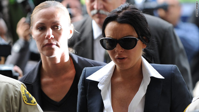 Actress Lindsay Lohan, in sunglasses, arrives for a court hearing where the judge imposed new bail conditions.