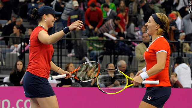United in victory. Kleybanova (left) and Kuznetsova celebrate their doubles triumph.