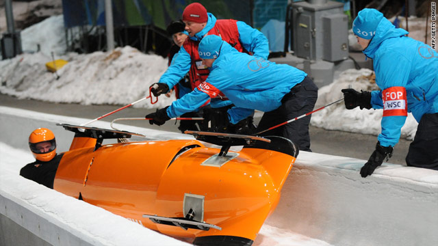Edwin van Calker's sled crashed in the first training heat of the men's two-man bobsled event.