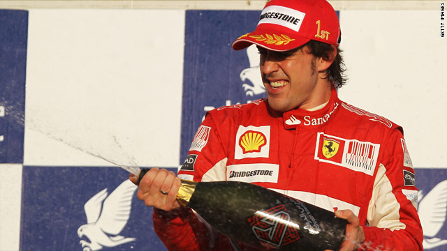 Fernando Alonso celebrates after securing his third victory at the Bahrain Grand Prix, having won it twice at Renault.