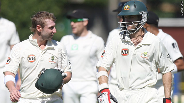 Australian batsmen Phillip Hughes (L) and Simon Katich leave the field after they secured a ten wicket win over New Zealand.