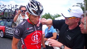 Lance Armstrong is helped after he crashed Thursday at the Tour of California hours after he denied Landis' allegations.