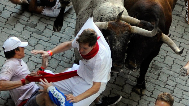 One runner is caught during the San Fermin Festival bull run, on July 07, 2010, in Pamplona, northern Spain.