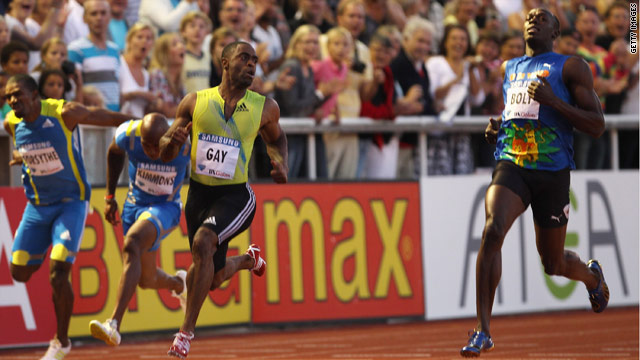 Tyson Gay looks across to his rival Usain Bolt, right, after beating the Jamaican in the 100 meters on Friday.